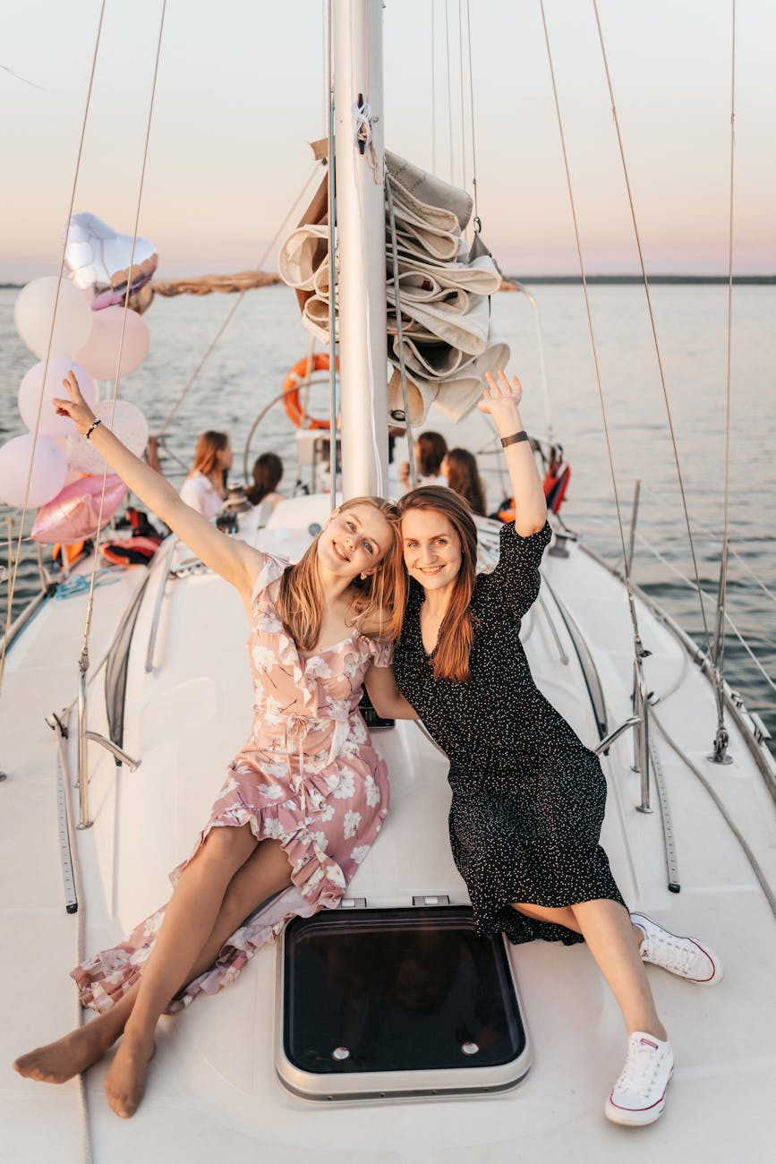 woman in black and white floral dress sitting on boat